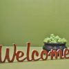 Medinis pastatomas užrašas "Welcome"